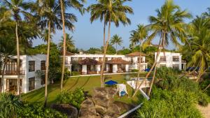 an aerial view of a resort with palm trees at Kumu Beach By Teardrop Hotels in Balapitiya +34 photos