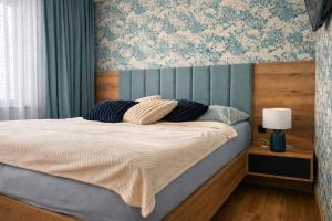 a bed with two pillows on it in a bedroom at Apartmán Alica Tále in Bystrá