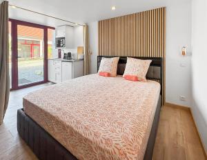 a bedroom with a large bed with two pillows at Les 4 AS de Jaunay, Intime, Jacuzzi in Jaunay-Clan +21 photos