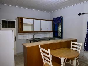 a kitchen with a table and chairs and a sink at Belle view Villa in Serekunda