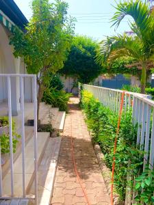 a garden with a hose attached to a fence at Belle view Villa in Serekunda