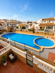 a large swimming pool on top of a building at Almohabenos Pool View in Punta Prima