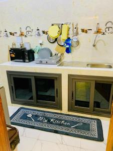 a kitchen with a counter top with a sink at Kër-Mame Tawfekh in Thiès