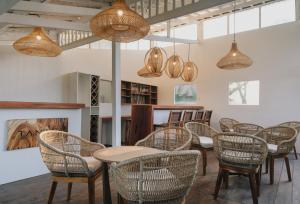 a group of tables and chairs in a room with lights at Tanahi Gili Air in Gili Islands