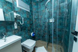 a bathroom with a shower and a toilet and a sink at Nova Prime in Bodrum City +10 photos