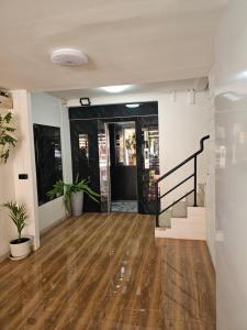 a living room with a wooden floor and stairs at Candy Beach Seaview Jomtien in Jomtien Beach