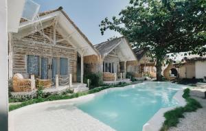a swimming pool in front of a house at Tanahi Gili Air in Gili Islands