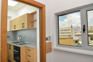 a kitchen with a window and a view of a building at Хотел КО НИ КО in Stara Zagora
