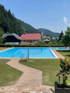 a large swimming pool in the middle of a park at Haus König in Kirchbach