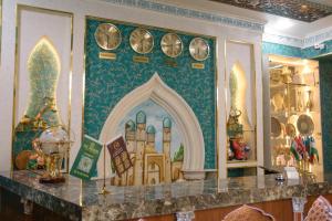 a counter with clocks on a wall in a store at Dendi hotel bukhara in Bukhara