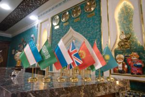 a row of international flags on a table at Dendi hotel bukhara in Bukhara