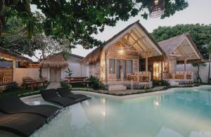 a house with a swimming pool in front of a house at Tanahi Gili Air in Gili Islands +36 photos