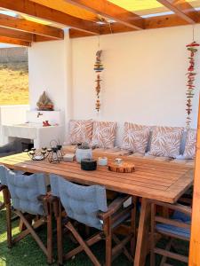a wooden table with a couch in a room at Apademia Comfort Studio 65sqm in Skiros