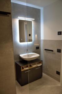a bathroom with a sink and a mirror at Junior Suite agli Archetti in Torri del Benaco +8 photos