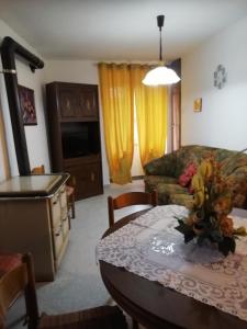 a living room with a couch and a table at Casa Relax in Carunchio +10 photos