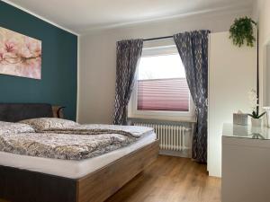 a bedroom with a bed and a window at Ferienwohnungen in Böhme in Böhme
