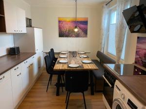 a kitchen with a table with chairs and a dining room at Ferienwohnungen in Böhme in Böhme