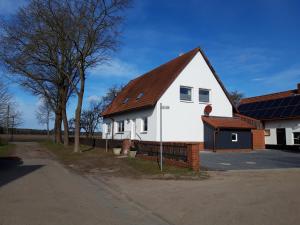 a white house with a brown roof at Ferienwohnungen in Böhme in Böhme