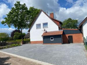 a large white house with a garage at Ferienwohnungen in Böhme in Böhme +6 photos