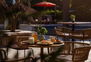 a table with a plate of food on a patio at Hotel Aquarius Dubrovnik in Dubrovnik