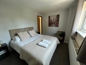 a bedroom with a bed with two pillows on it at The Nook in Bedford
