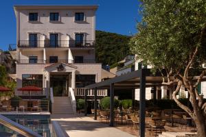 a hotel with a pool in front of a building at Hotel Aquarius Dubrovnik in Dubrovnik
