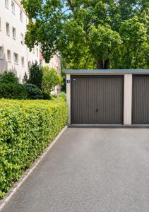 a driveway with a garage in front of a building at Nürnberg Central Flat in Nuremberg