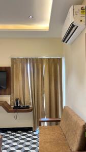 a living room with a couch and a window at RS Galaxy Near AIMS Rishikesh in Rishīkesh