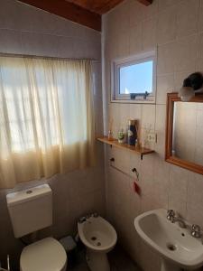 a bathroom with a toilet and a sink at depto felix 1 in Santa Rosa