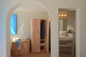 a bathroom with a sink and a mirror at White Pearl Villas in Oia +57 photos
