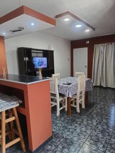 a dining room with a table and chairs and a television at depto felix 1 in Santa Rosa