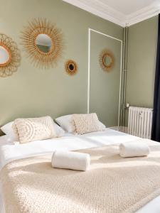 a bedroom with a large white bed with mirrors on the wall at l'Ecrin Bellevue in Aix-les-Bains