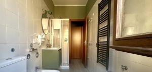a bathroom with a sink and a toilet and a mirror at Nextop Homes in Tortona