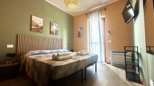a bedroom with a bed with towels on it at Nextop Homes in Tortona +18 photos