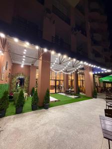 a building with a courtyard with potted plants and lights at All seasons in Gonio beach in Gonio