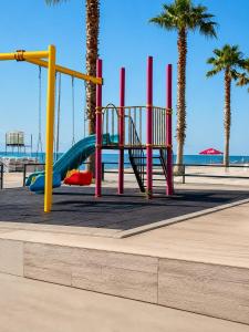 a playground on the beach with palm trees at All seasons in Gonio beach in Gonio