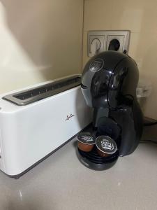 a coffee maker sitting on a counter with two cups at Dumar Puerto Rey in Vera