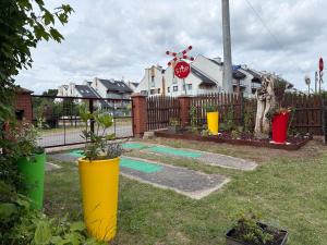 a yard with a stop sign and some plants at Arkadia - Amber in Jantar +15 photos
