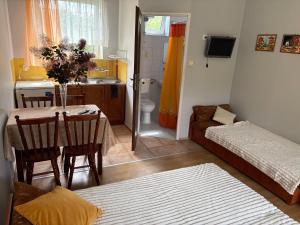 a small living room with a table and a couch at Arkadia - Amber in Jantar
