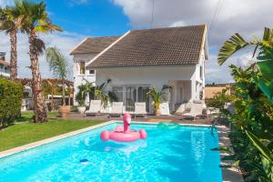 a house with a swimming pool in front of a house at Retreat Villa, Hot tub, BBQ in Lisbon