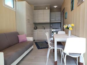 a living room with a couch and a table and chairs at Total Relax Home by Holiday World in Framura