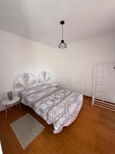 a bedroom with a bed and a ladder in it at La casita de llanda in Suances