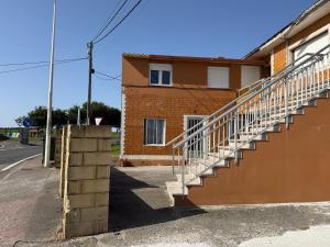 a building with a staircase on the side of a street at La casita de llanda in Suances