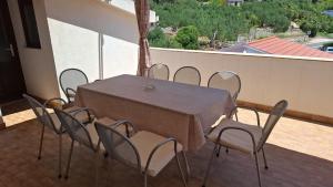 a table and chairs sitting on a balcony at Stanka in Podgora