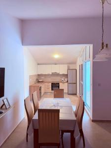 a kitchen and dining room with a table and chairs at Stanka in Podgora