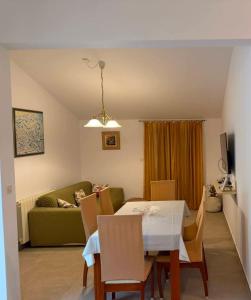 a living room with a table and a green couch at Stanka in Podgora