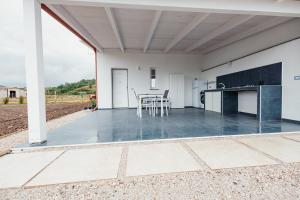 a patio with a table and chairs on it at Tenuta Mari in Castelnuovo Cilento