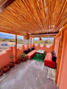 a living room with a couch and a table at Amzil Surf House in Aourir