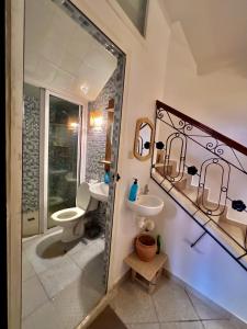 a bathroom with a sink and a toilet at Amzil Surf House in Aourir