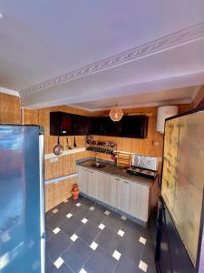 a kitchen with a checkered floor and a counter top at Amzil Surf House in Aourir +20 photos